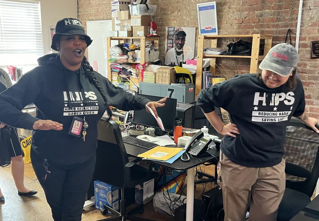 two people talk to journalists