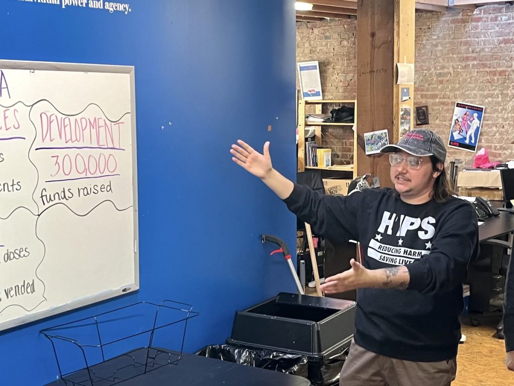 person pointing to a whiteboard with HIPS statistics