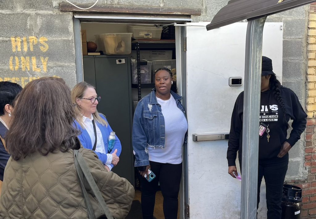 person speaking to journalists outside
