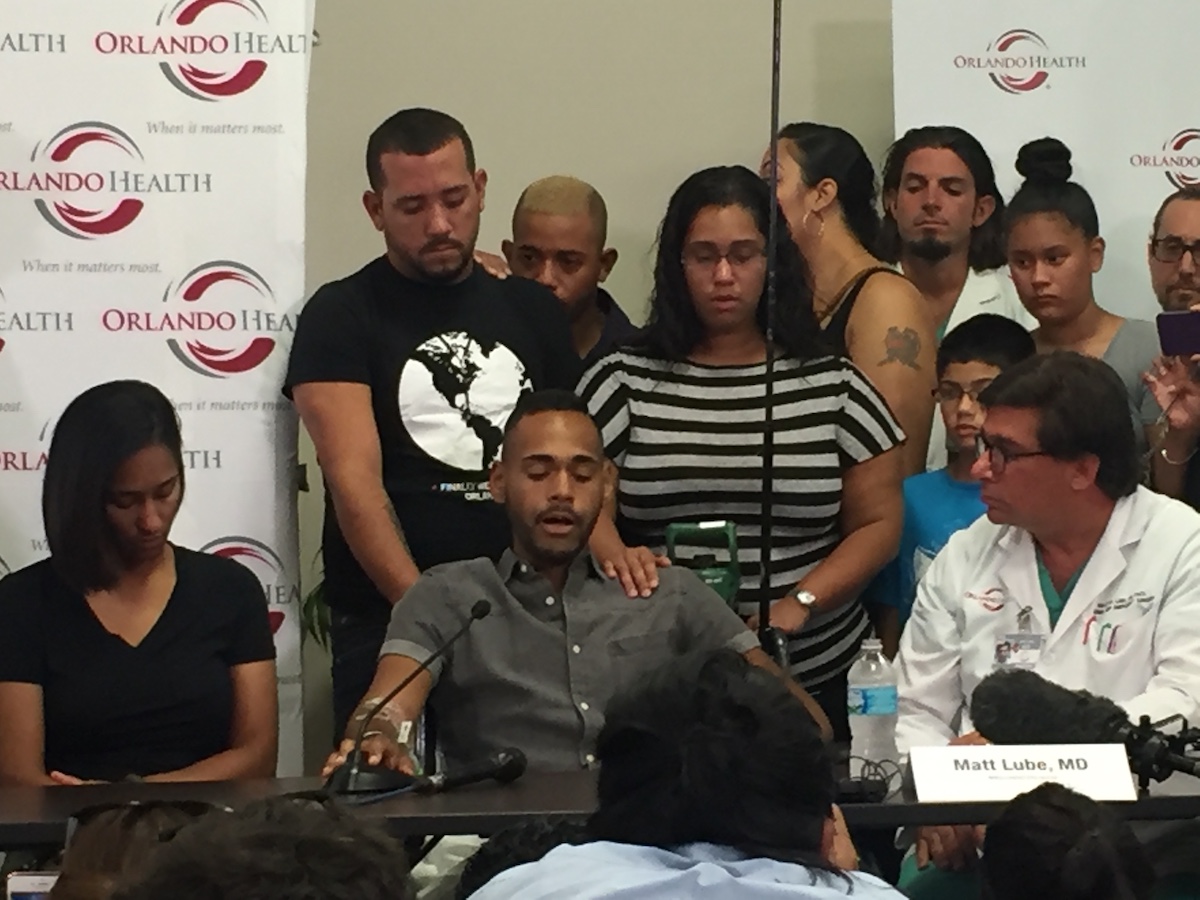 A survivor of the Pulse nightclub shooting is comforted by family members at a news conference in June 2016