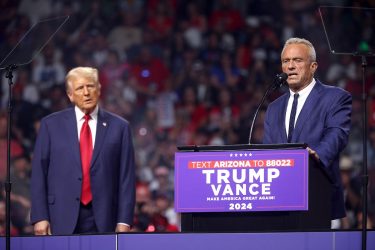 Robert F. Kennedy Jr. speaking at a Trump rally next to Donald Trump