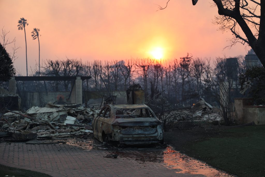 a burned car on a property damaged by the LA fires in January 2025