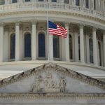 capitol building with flag at half mast in foreground. gun violence featured image