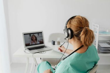 health care provider communicating with a patient via telehealth