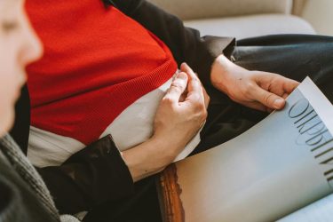 pregnant woman holding her belly