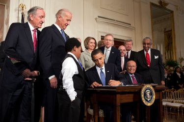 Former President Barack Obama signs the Affordable Care Act into law in 2010.