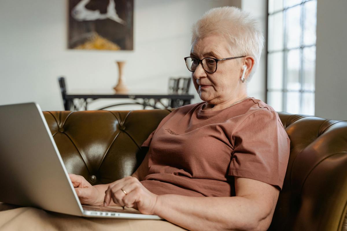 an older adult using a computer for a telehealth appiontment