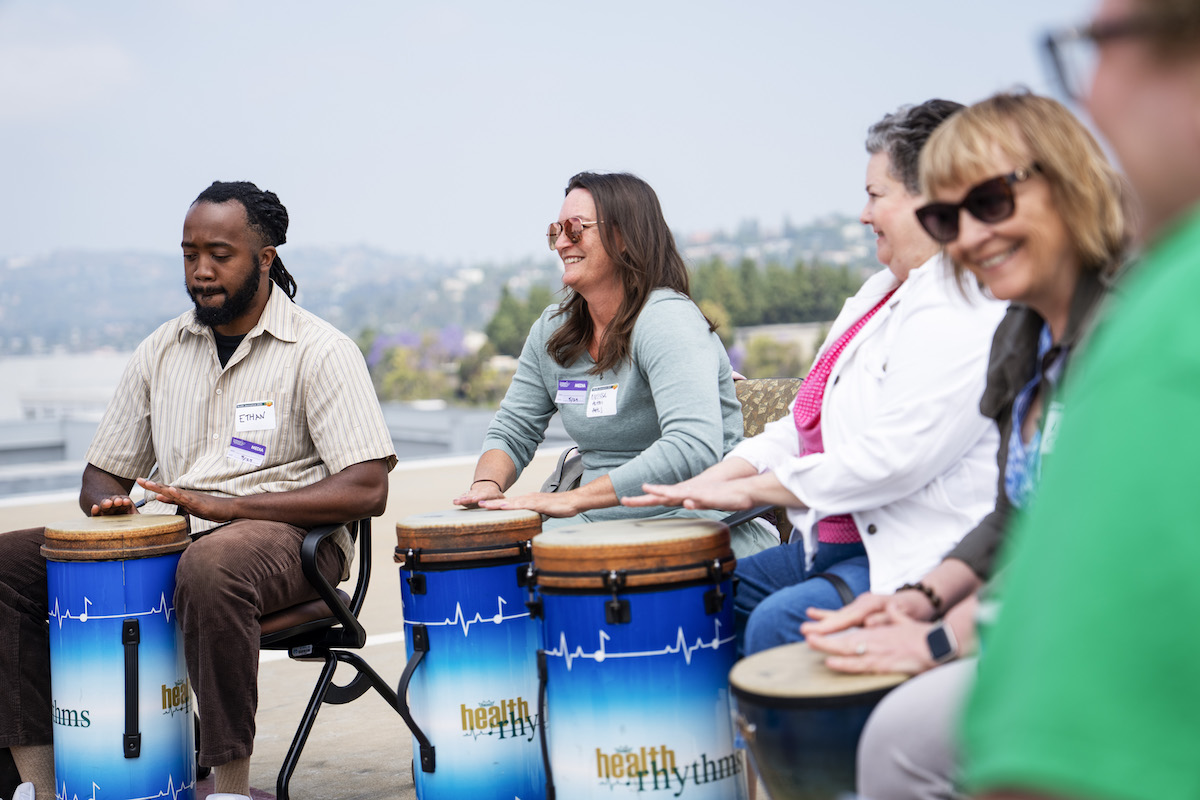 HJ25 field trip attendees playing drums
