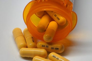 500mg capsules of amoxicillin manufactured by Sandoz on a plate. The CEO of the generic pharmaceutical maker warned that tariffs could threaten patient access to low-cost meds. Photo by Henry S Zhang (CC BY 4.0)