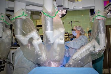 A Landstuhl Regional Medical Center surgical staff member positions a minimally-invasive robotic surgical system during an operation at LRMC, Jan. 12, 2022.