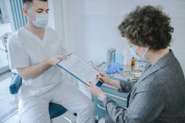 person signing a medical consent form