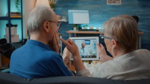 an older man and woman using telehealth