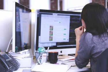 woman sitting at computer using an AI tool