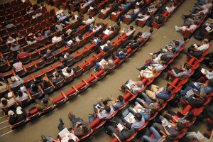 a birds-eye view of an audience in an auditorium. gun violence prevention summit featured image