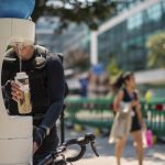 person refilling their water bottle in extreme heat