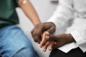 doctor holding a patient's hand. harm reduction center