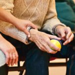 older adult holding a stress ball. aging featured image