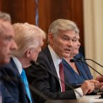 CMS Administrator Dr. Mehmet Oz talks into a microphone next to President Trump and HHS Secretary Robert F. Kennedy Jr. in July 2025