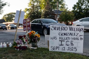 A roadside memorial for Silverio Villegas González, a 38-year-old man who was shot and killed by an unidentified ICE officer in a suburb of Chicago. A prominent sign reads: "Silverio Villegos Gonzalez (RIP) was killed here by I.C.E. Sept. 12, 2025."