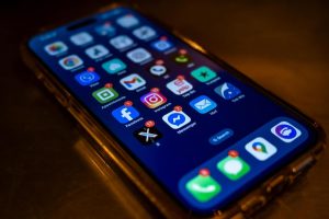iPhone with multiple social media apps on it