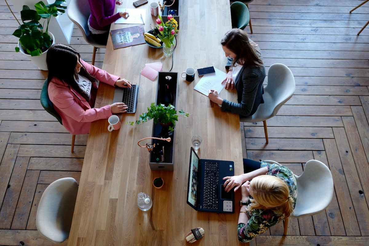 accountability partners working on computers in a co-working space.