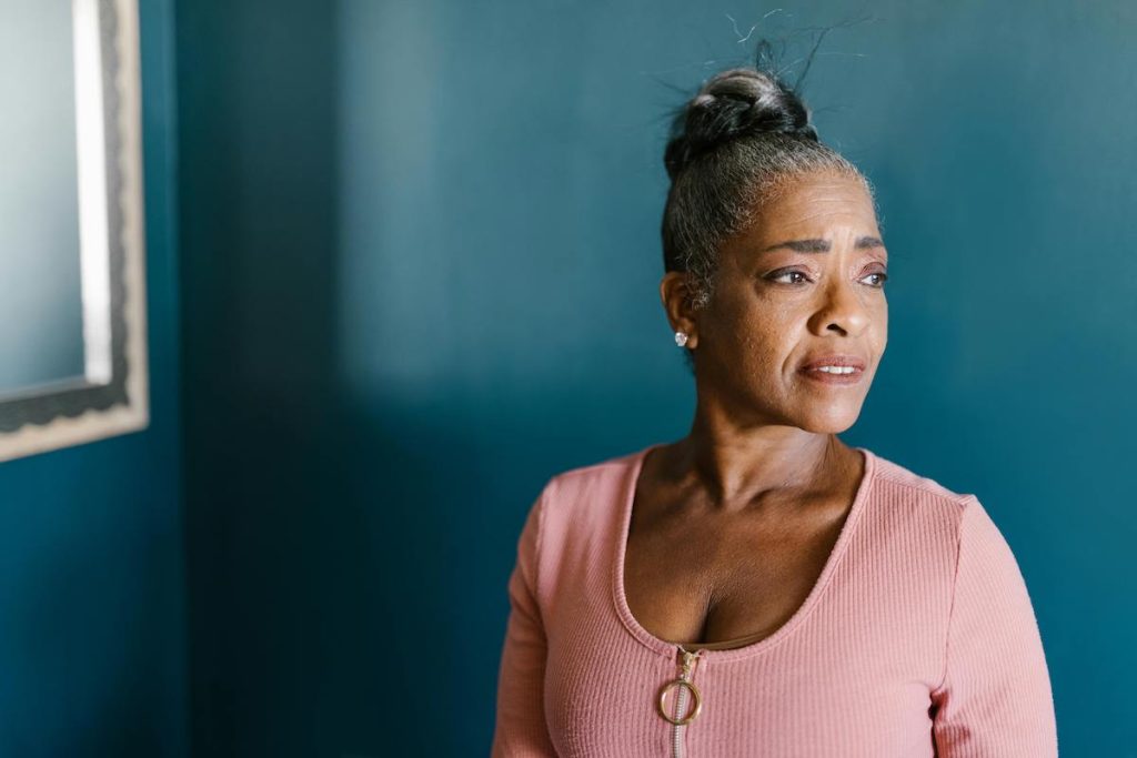 Black woman in a blue room. Menopause