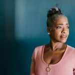 Black woman in a blue room. Menopause