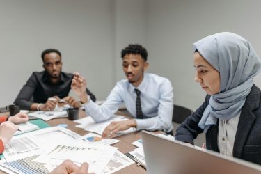 people sitting around a table discussing gun violence research