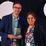 Bob Herman, holding the inaugural Sunshine Award, standing next to Joyce Frieden.