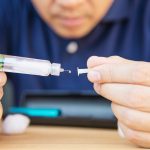 man preparing a semaglutide injection