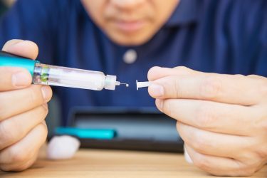 man preparing a semaglutide injection