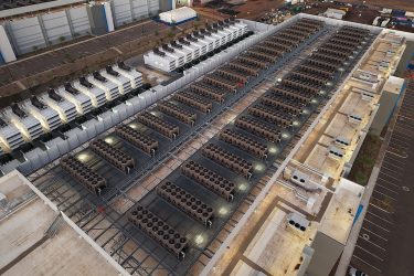 The roof of a data center near Gilbert, Ariz., featuring cooling towers and backup generators. Public domain photo by Rsparks3