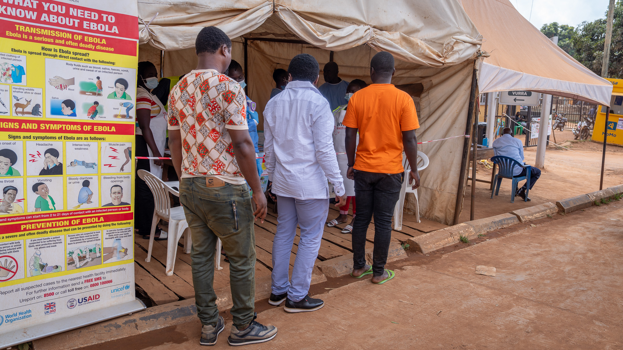 Point of entry screening at Vurra border crossing between Uganda and the Democratic Republic of the Congo, Arua District, Uganda, 24 June 2026. Uganda's Ministry of Health, supported by the World Health Organization (WHO) and partners, promptly began point of entry screening on 16 May 2026, a day after the Ebola outbreak was declared. Screening was first introduced at major designated points of entry before expanding rapidly to additional locations. By the fifth day of the response, screening activities had been scaled up to 29 points of entry, eventually reaching 34 priority sites across the country. When travellers arrive at or depart from any airport, land border crossing and other designated point of entry and exit, their temperature is taken and recorded. They scan the QR code and complete the self-declaration form, which records their contact details, biodata, history of travel and any signs and symptoms of Ebola disease. These tools support the collection of traveller information and facilitate follow-up where public health action is required. "Outbreaks start in communities," says Adia Biajo, a data clerk at Arua border's screening point. "It is very important to start with screening so that outbreak can come to an end."