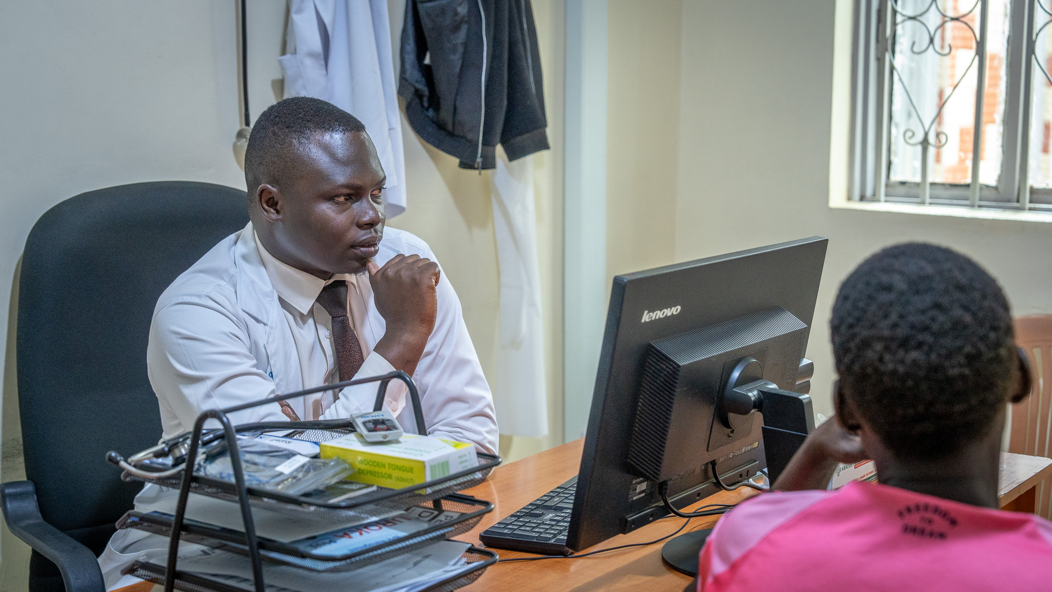 At Novafinia clinic in Arua, a border town in northern Uganda, staff are on high alert after unsuspectingly attending to a patient who was later diagnosed with Ebola disease caused by the Bundibugyo virus. It was 8 May 2026, before the outbreak was declared in neighbouring Democratic Republic of Congo, and the staff’s index of suspicion was low. After the patient asked to be discharged, she travelled to Kampala, Uganda’s capital city, where she tested positive before returning to the Democratic Republic of Congo. “Once we got the call from the district surveillance team, we were concerned and anxious, ” says Dr Seth Ejuu, the medical officer at the clinic who treated the patient for fever and abdominal pain. The district surveillance team advised Ejuu and a nurse who attended to the patient to self-isolate for 21 days. Thankfully they experienced no signs or symptoms and are now back at work. “It was our standard operating procedures, for example, the use of gloves and hand sanitizer when we treat our patients, that helped us mostly, ” he says. This experience caused the clinic to immediately step up preparedness measures while continuing to provide health services in an environment that is safe for both health workers and their clients. Maintaining access to essential health services is an important part of any disease outbreak response. Experience from previous health emergencies has shown that disruptions to routine healthcare can lead to indirect health consequences, including missed immunizations, interruptions to maternal and child health services, delayed treatment for chronic diseases and reduced access to emergency care. Novafinia clinic implemented a multipronged approach, which includes handwashing stations at the two entrances to the clinic and a hand sanitizer station at reception. There is client spacing at reception to avoid unnecessary contact, a one-way flow to a dedicated triage area, and correct and consistent use of personal protective equipment for health care workers. “We have also provided people with the right information about the disease and how they can protect themselves, ” says Dr Alex Kigera, medical officer in charge of Novafinia clinic. Information boards are prominently displayed at the entrance and the interior of the clinic and Kigera has a weekly guest slot on a radio show. © WHO / Natalie Ridgard