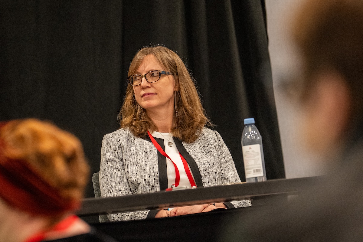 Katie Martin, president and CEO of the Health Care Cost Institute, listens during a panel on health care affordability. Photo by Zachary Linhares