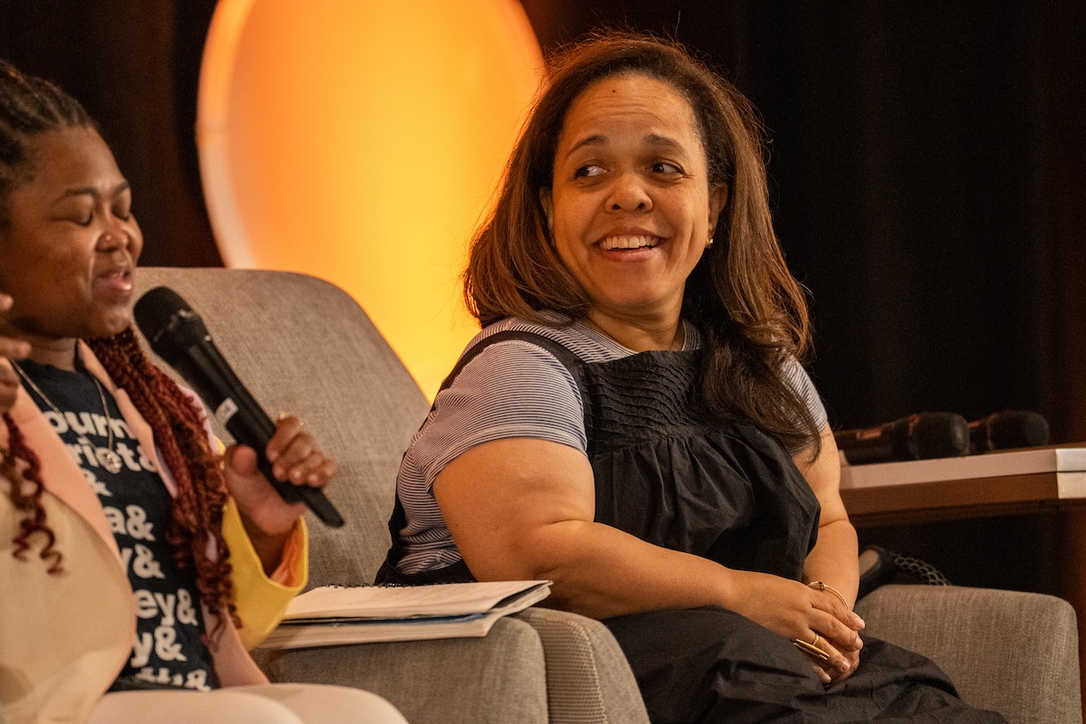 Cara Reedy, founder and director of the Disabled Journalists Association, laughs as fellow panelist Ericka A. Dixon speaks at HJ26. Photo by Zachary Linhares