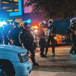 Police and SWAT members in riot gear. The practice of "swatting" hospitals is posing a growing threat.