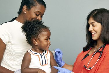 A child receives a vaccine from a primary care provider.