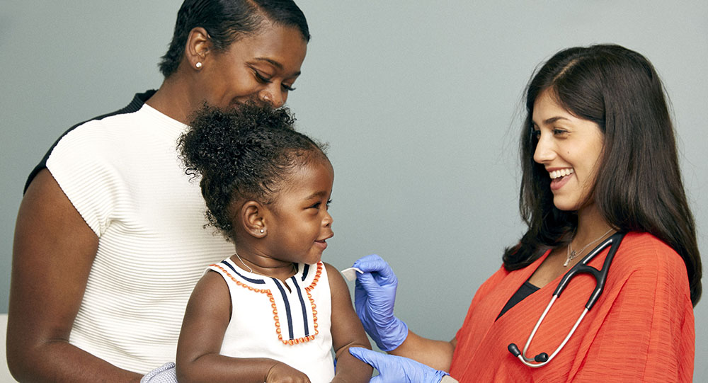 A child receives a vaccine from a primary care provider.