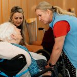 An older woman talking to caregivers. dementia care violence featured photo
