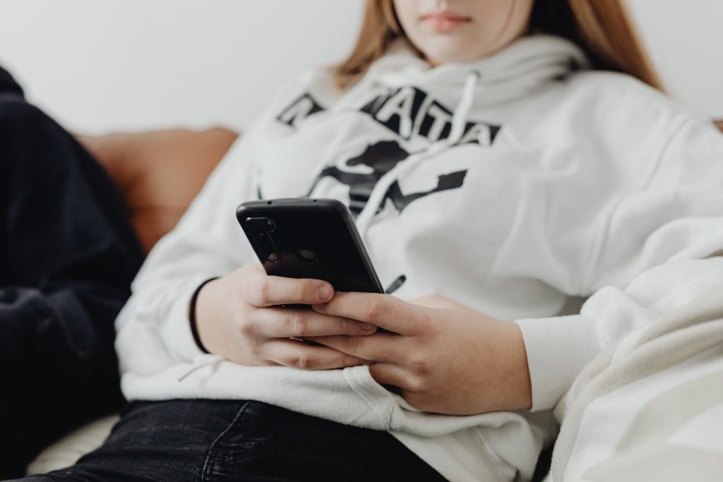 a teenage girl looking at her cell phone. Headlines about youth mental health follow a familiar pattern: Teen anxiety is rising. Depression is increasing. Suicide rates have climbed. Then comes the inevitable question: Is social media and too much screen time to blame? Researchers say that may be the wrong question.
