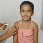 A child receiving a vaccine. SchoolVaxView featured image