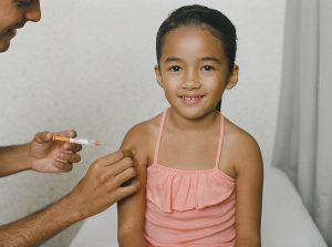A child receiving a vaccine. SchoolVaxView featured image