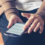 person using a mental health app on a phone