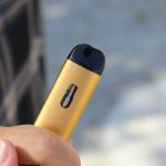 a hand holding a vape pen for vaping
