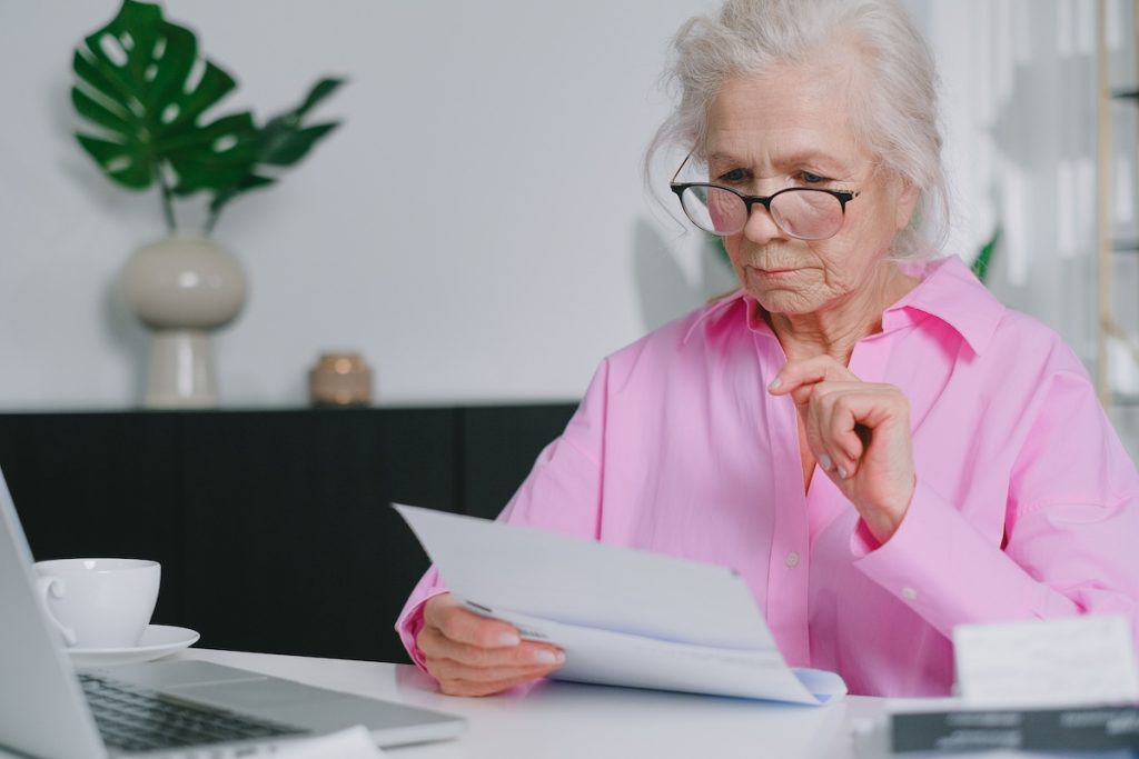 an older woman completing Medicare enrollment forms