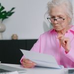 an older woman completing Medicare enrollment forms